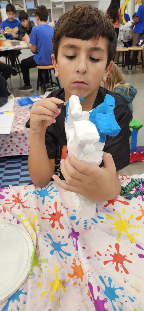 Students are working hard in art to finish painting their alebrije inspired animal sculptures. 