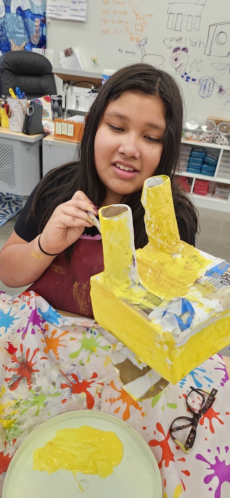 4th graders enjoying painting and patterning their alebrije inspired sculptures. 