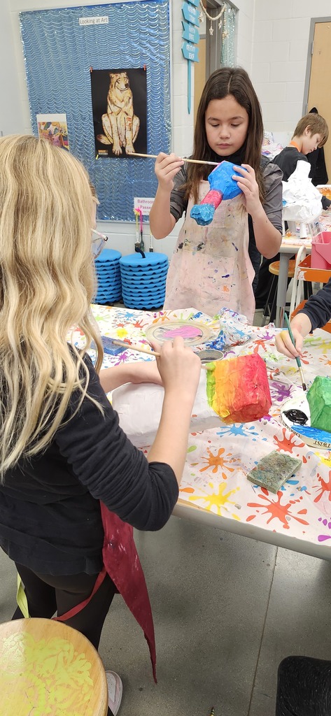 4th graders enjoying painting and patterning their alebrije inspired sculptures. 