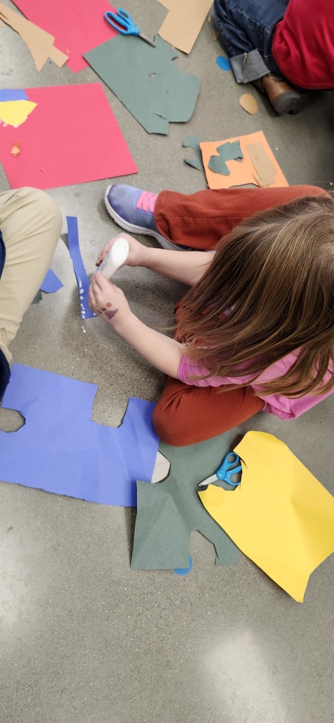 Kindergartners enjoying making cut paper collages. Look how good they are at using dots of glue too!