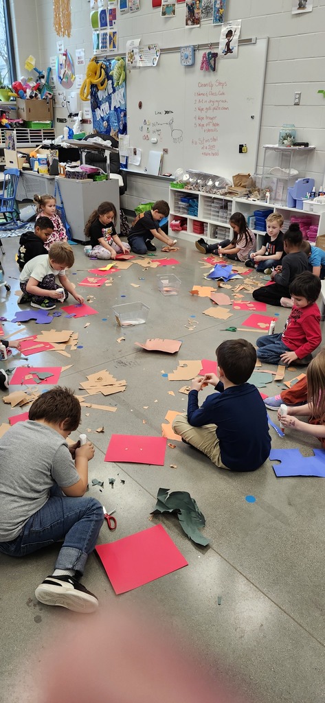 Kindergartners enjoying making cut paper collages. Look how good they are at using dots of glue too!