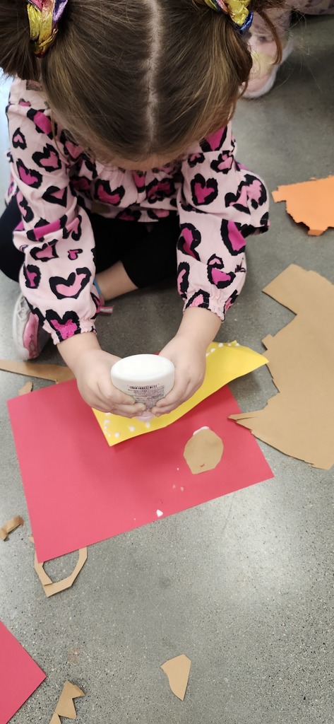 Kindergartners enjoying making cut paper collages. Look how good they are at using dots of glue too!