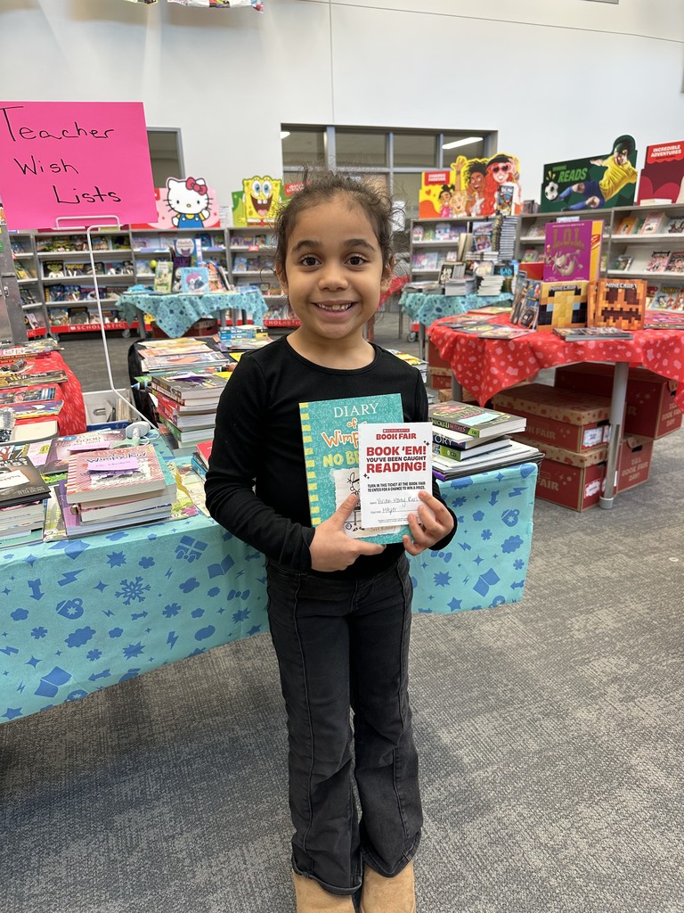 These friends were caught reading and won a free book from the book fair! Thanks to everyone who supported our book fair to support our readers and our library!