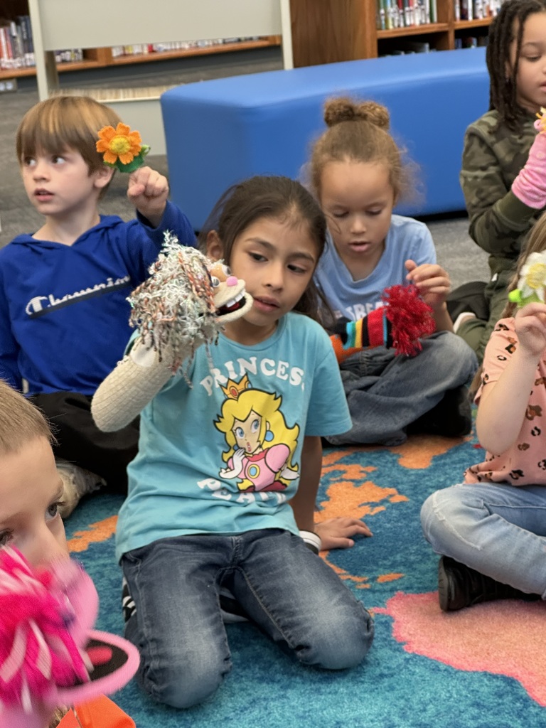 These kindergartners LOVED telling stories and using puppets with Ms. Nancy in library media class.