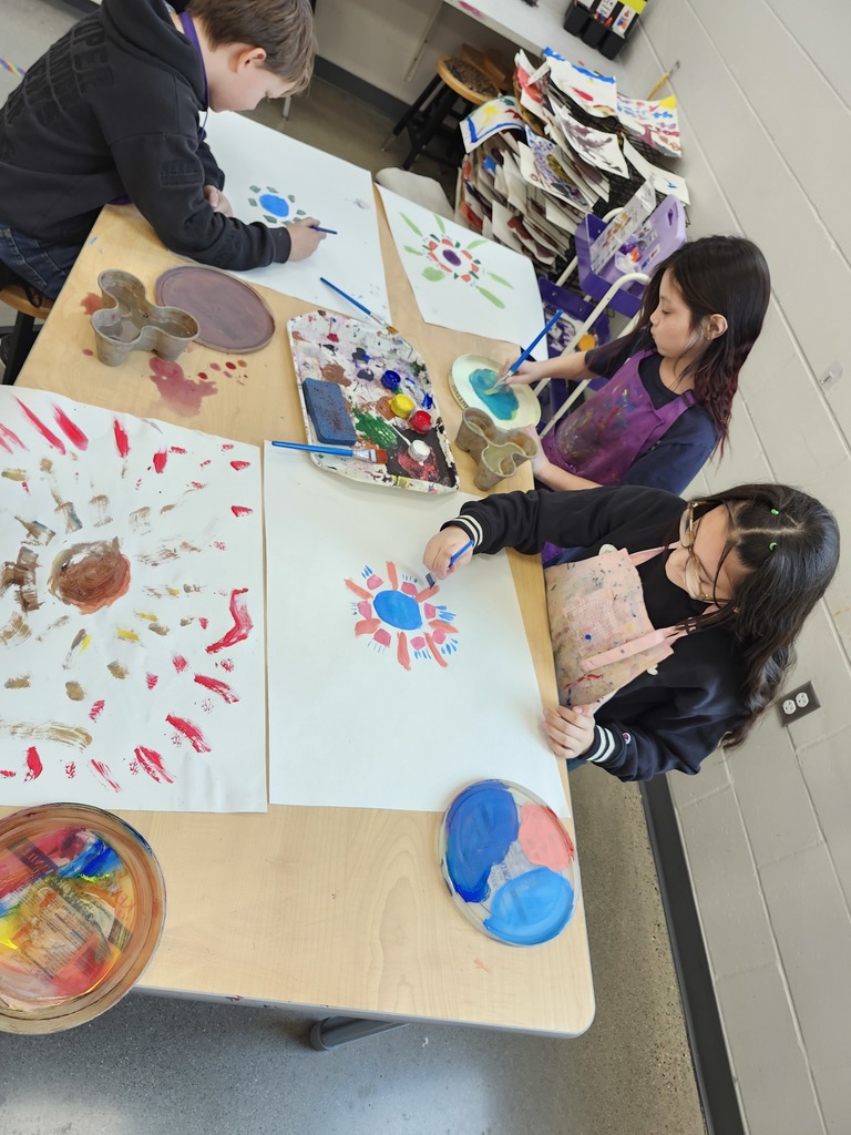 3rd graders practiced mixing colors and creating brushstrokes for radial designs.