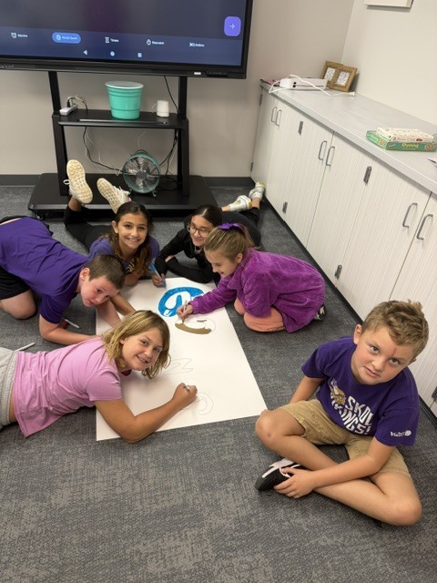 LSH Elementary student council creating posters for the float tomorrow!