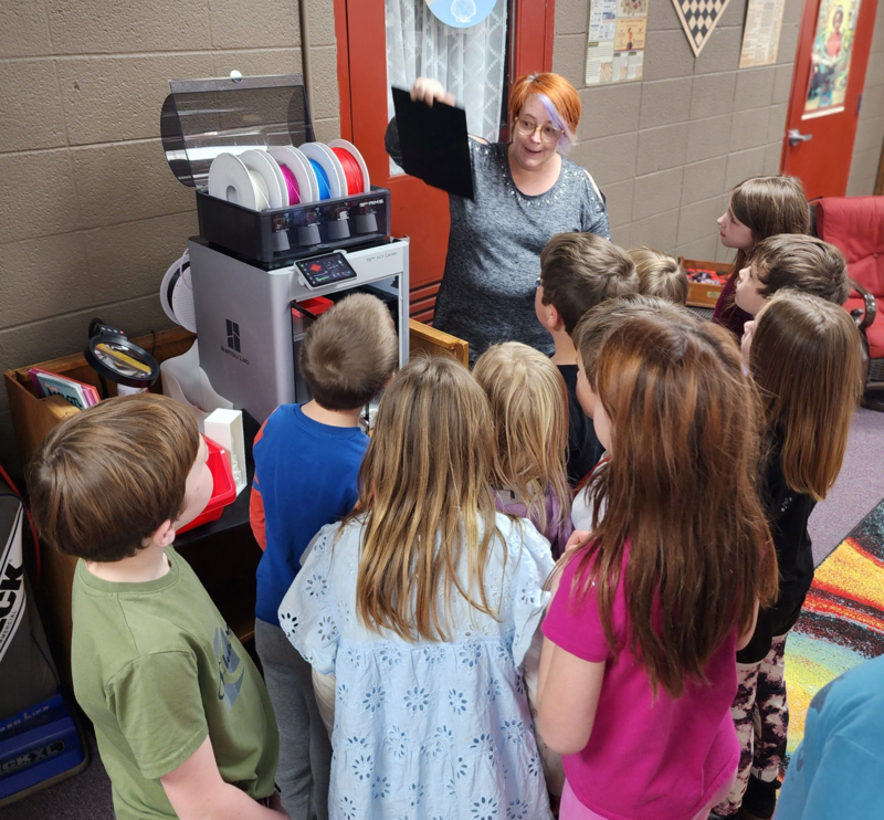 Teacher showing students device