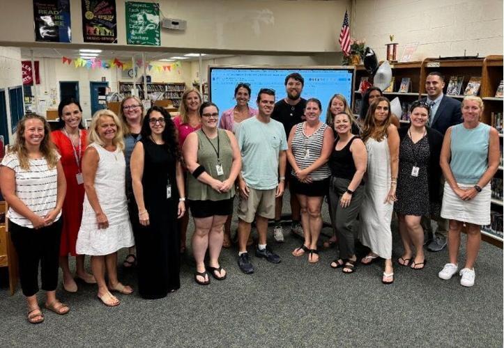picture of a group of teachers standing in the library