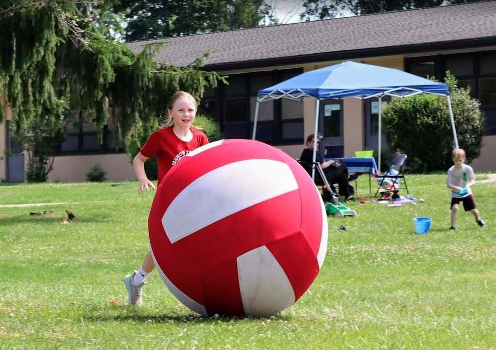 A student playing with a giant ball