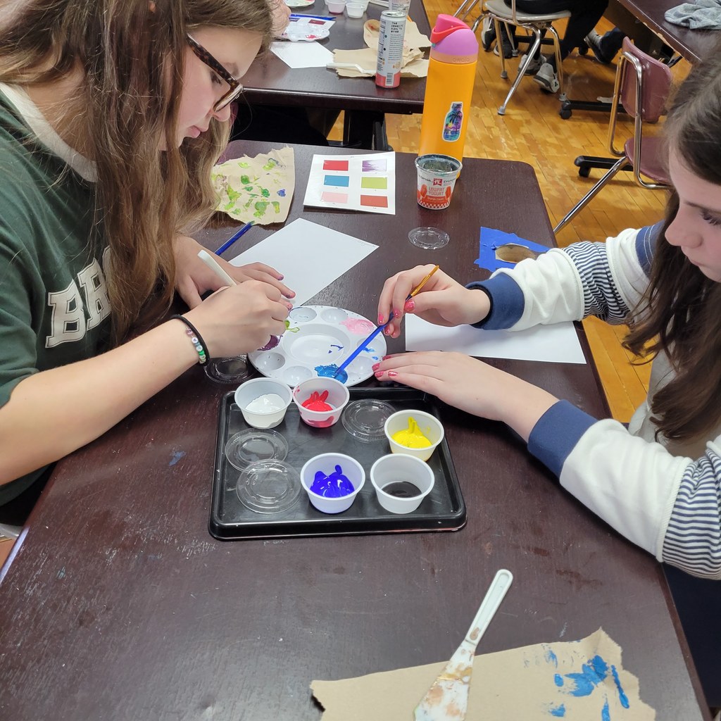 Students are mixing paint.