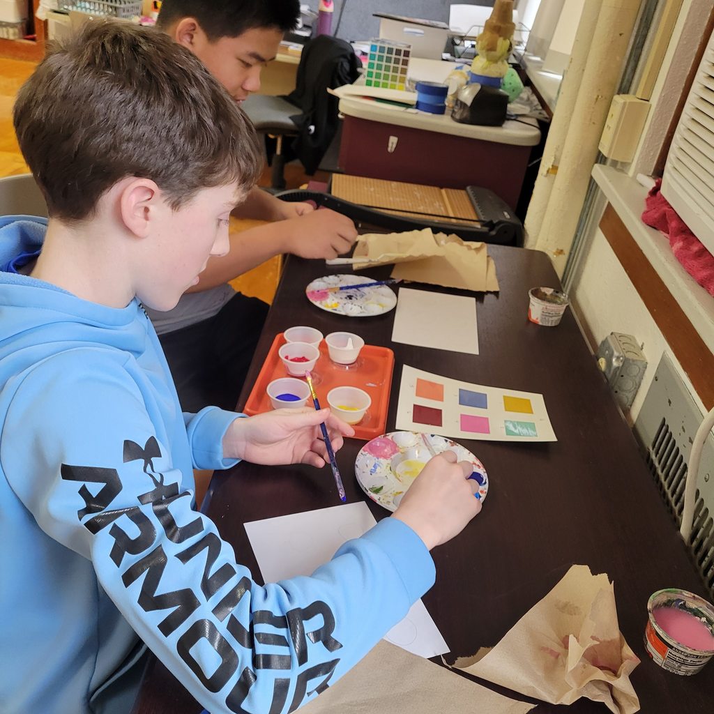 Students are mixing paint.