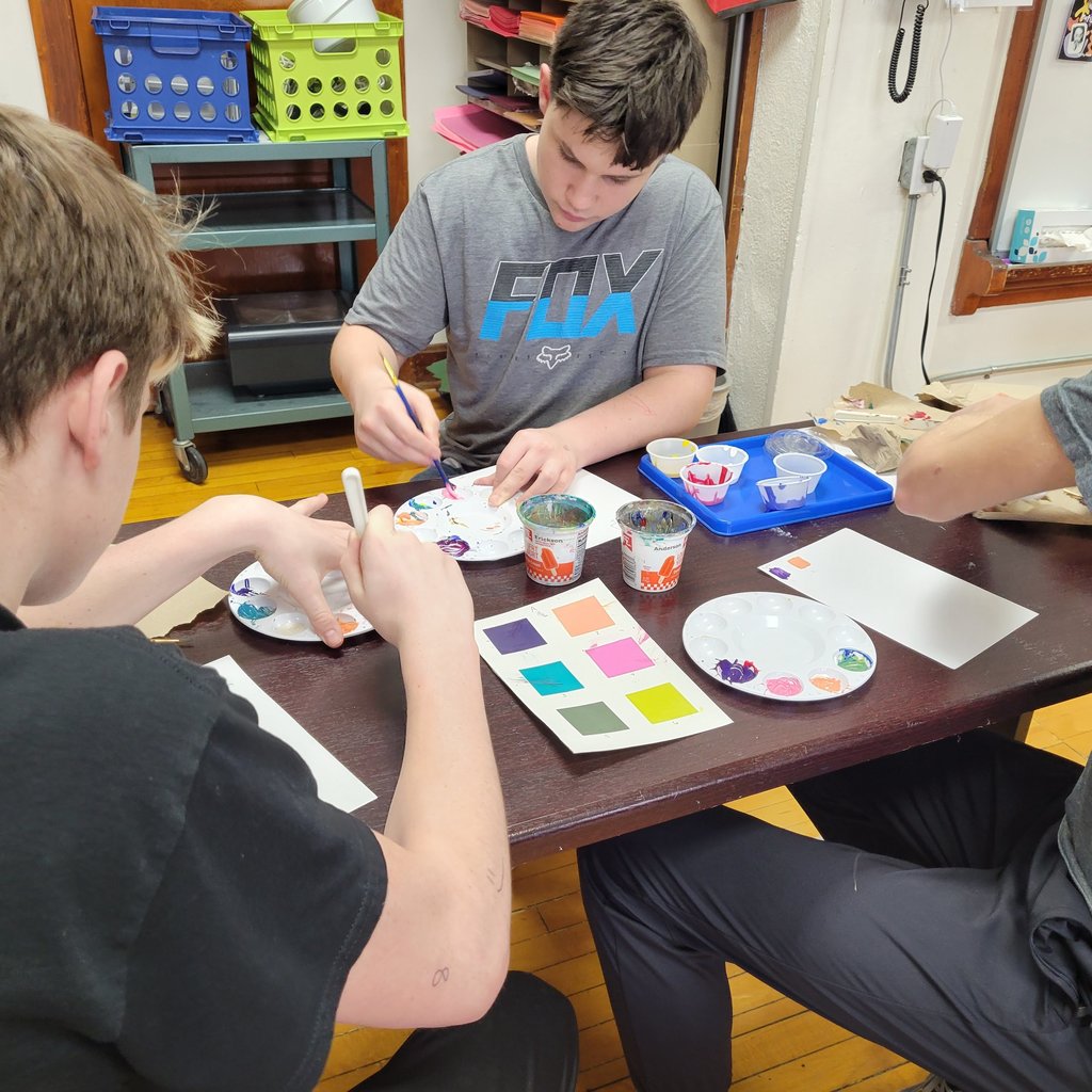 Students are mixing paint.