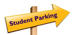 A yellow arrow mounted on a wooden post points to the right and reads, "Student parking"
