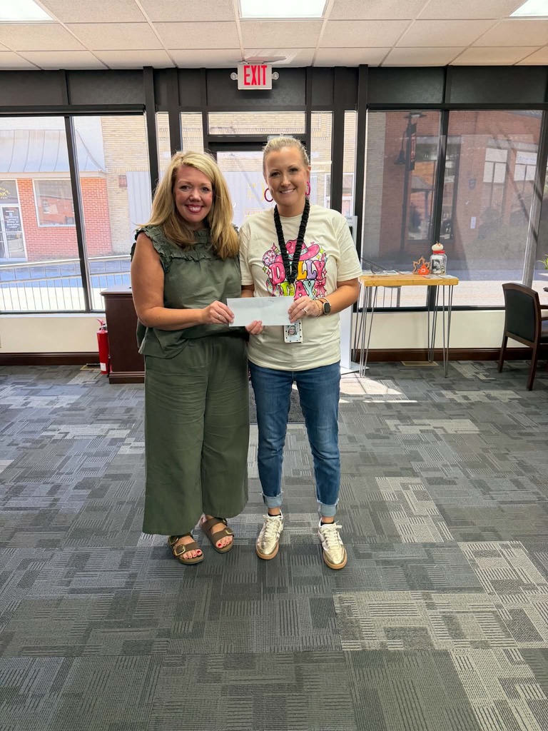 FRC Director, Hillary best accepts a donation from Citizens Bank & Trust. This money will be used to supply weekend food bags to students in need!
