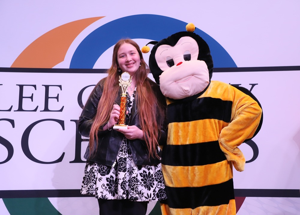 Molly Bauer poses with Bee after winning District Spelling Bee