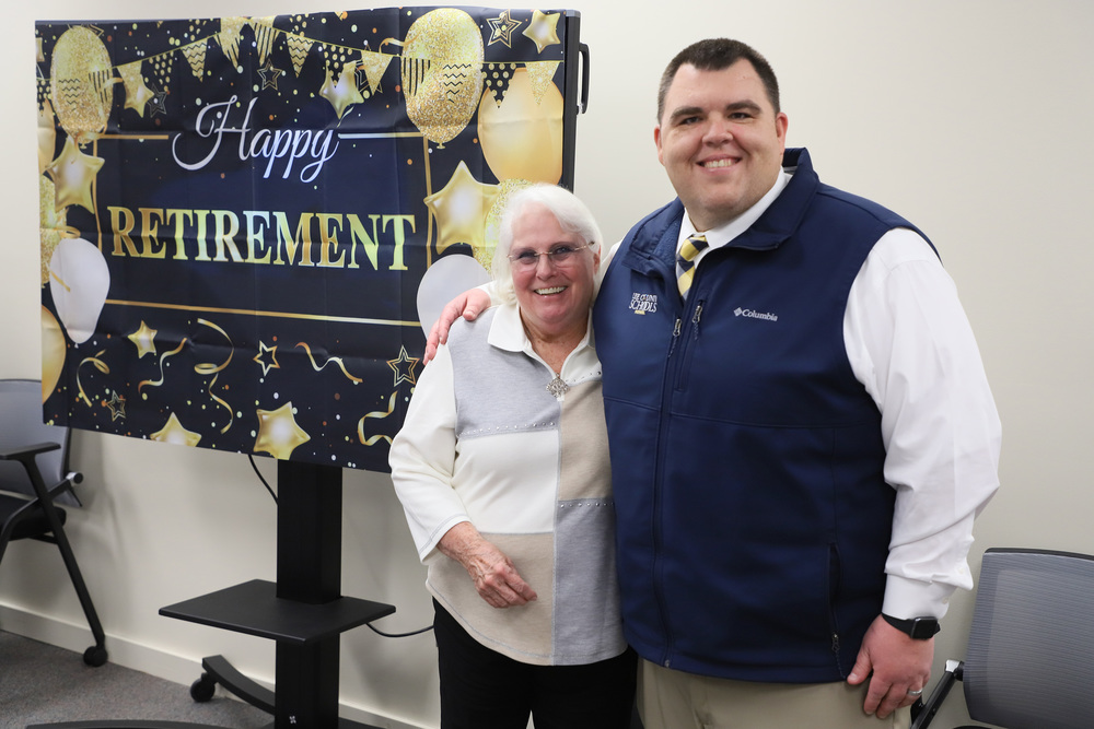 Becky Maddox poses with Dr. Dossenbach at a retirement celebration in her honor.