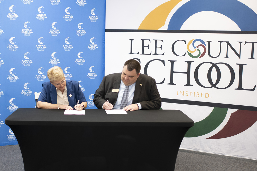 Dr Chris Dossenbach signs a MOU with CCCC for local residency program for aspiring teachers