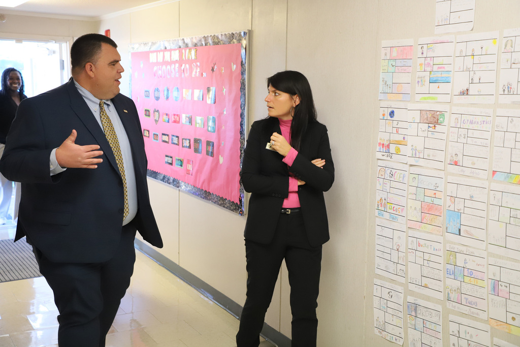 Dossenbach and Ashburn chat about education policy while walking the halls at Tramway Elementary