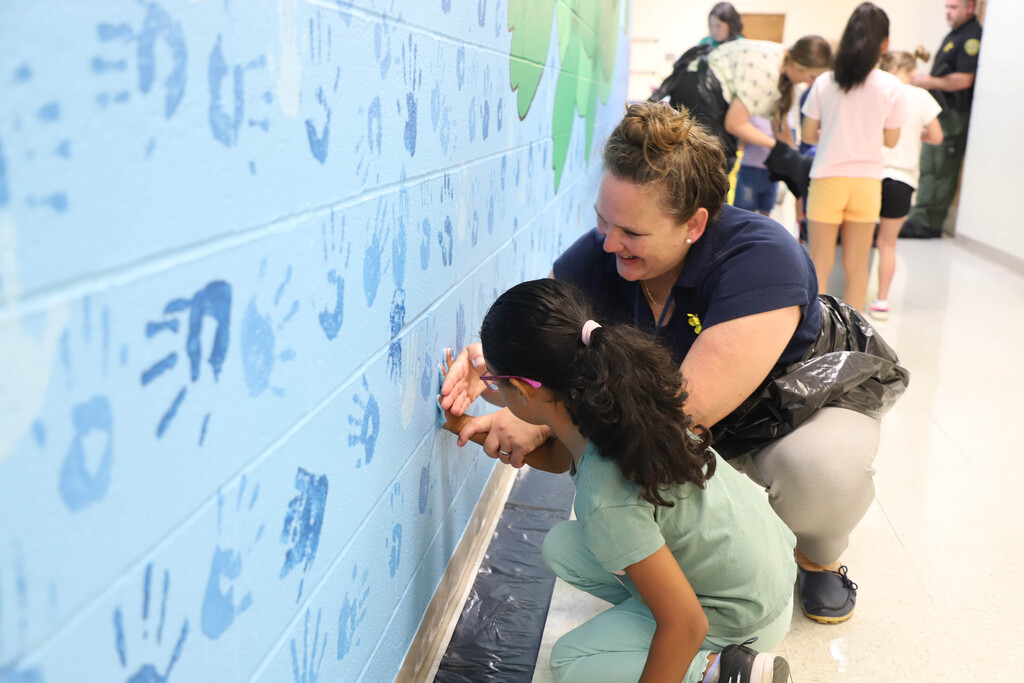 Deep River students participate in making a hand mural