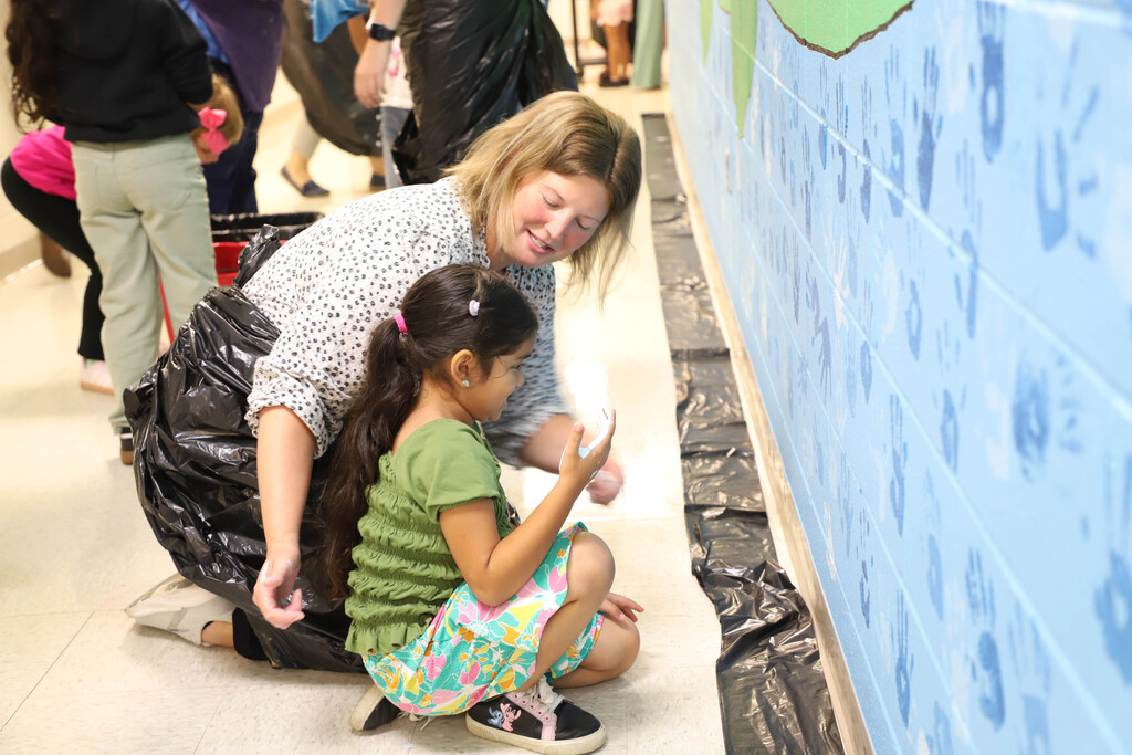 Deep River students participate in making a hand mural