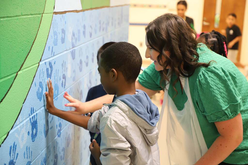 Deep River students participate in making a hand mural