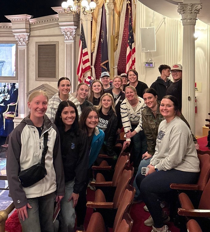 Students at Ford's Theatre with the booth where Lincoln was assassinated in the background. 