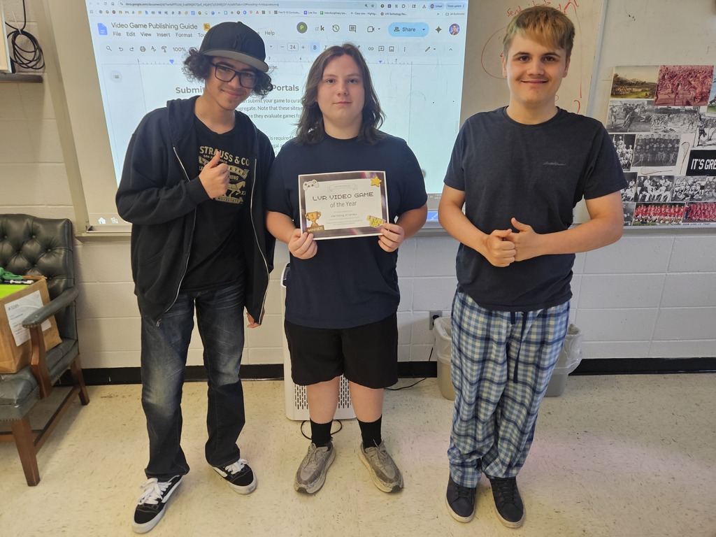 Three boys holding awards for video game design