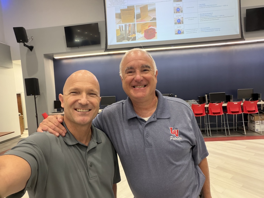 Eric Sheninger poses with Dr. Rossi during the Annual Leadership Retreat in the school media center.