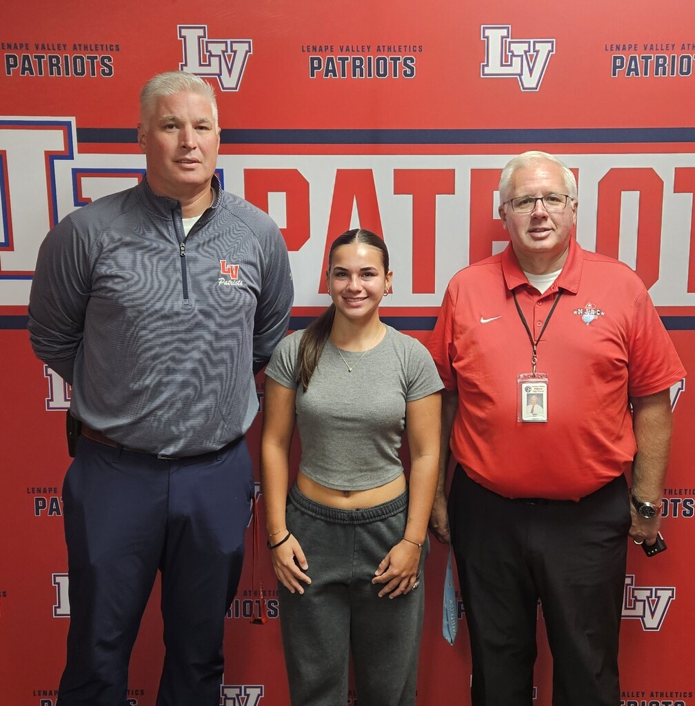 Kaidyen Gomez stands with Lenape Valley Regional High School Principal Doug Reynolds and Athletic Director Rob Cline while being recognized for breaking the school record for points in field hockey