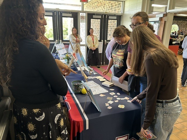 Students visit a Lenape Valley resource table during lunch while a member of the school clinical team shares mental health and self-care information and activities with them.