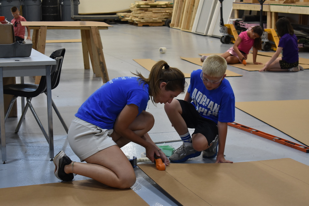 Teacher assisting student with his boat