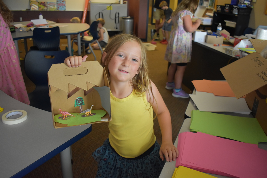 Student showing her dino habitat