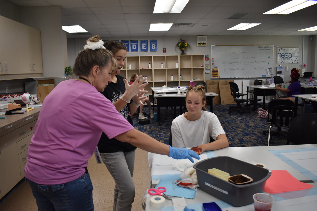 Students learning to dress wounds