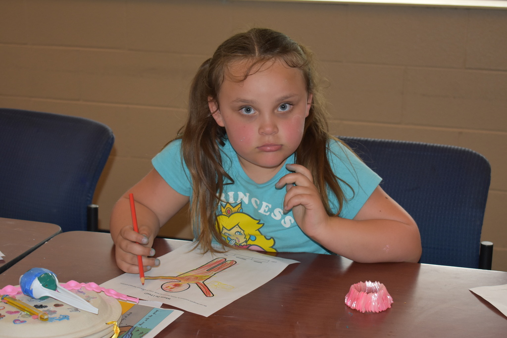 Student coloring an emotions page