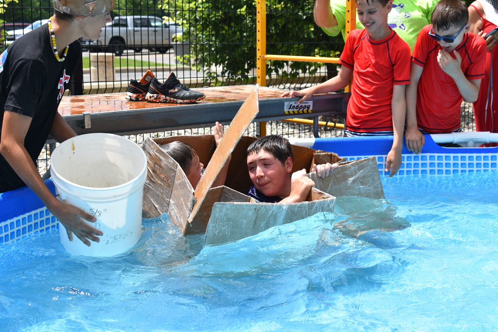 Two campers celebrate their boat success