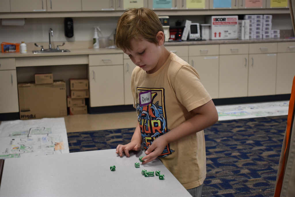 Student playing a math dice game