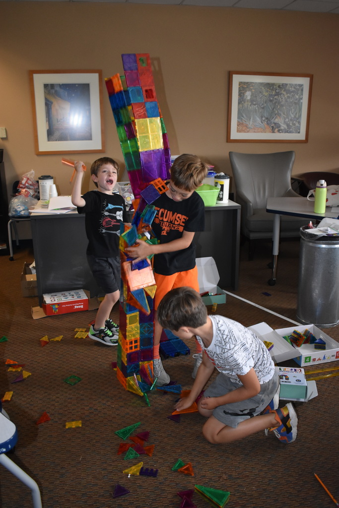 Students knocking over their tower