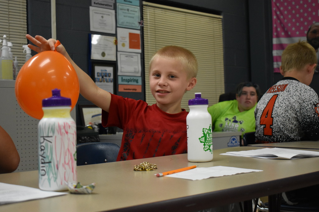Student showing balloon he blew up