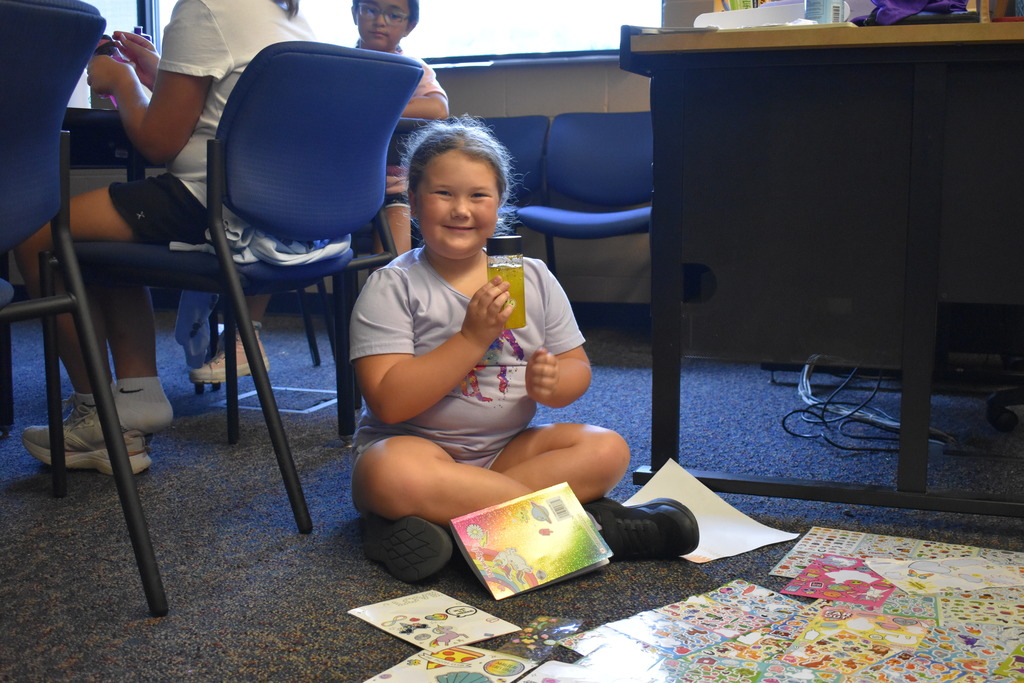 Student showing artwork