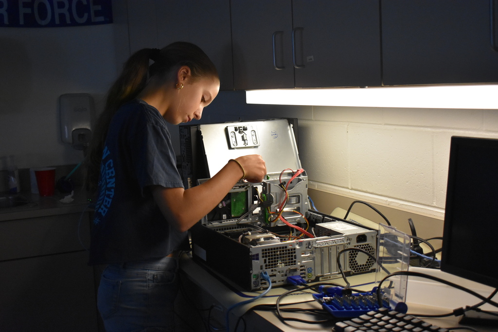 Student working on rebuilding a computer