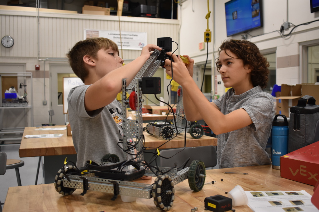 Two students building their robot