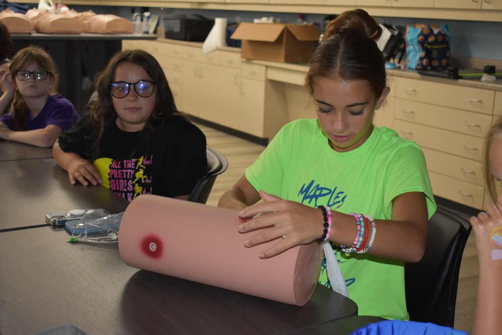 Student learning to pack a wound 