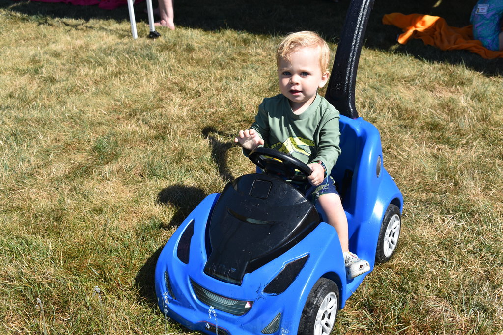 Little boy playing in riding car