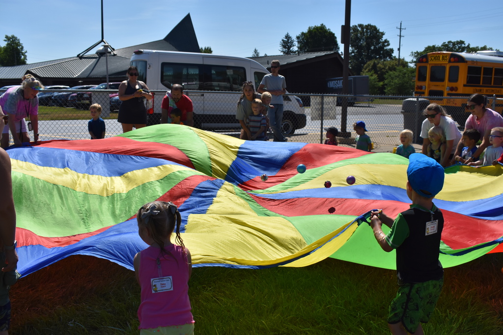 Kids using the parachute