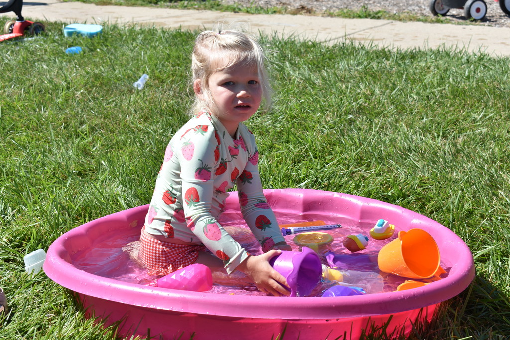 Little girl playing in pool