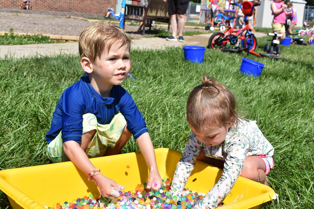 Two kids playing with water beads
