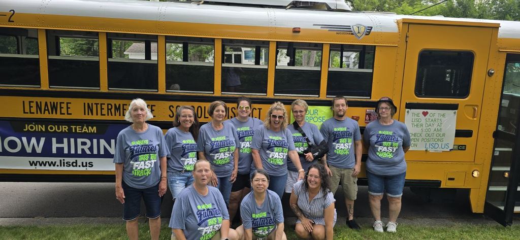 LISD team members standing outside the bus posing for a photo before the parade