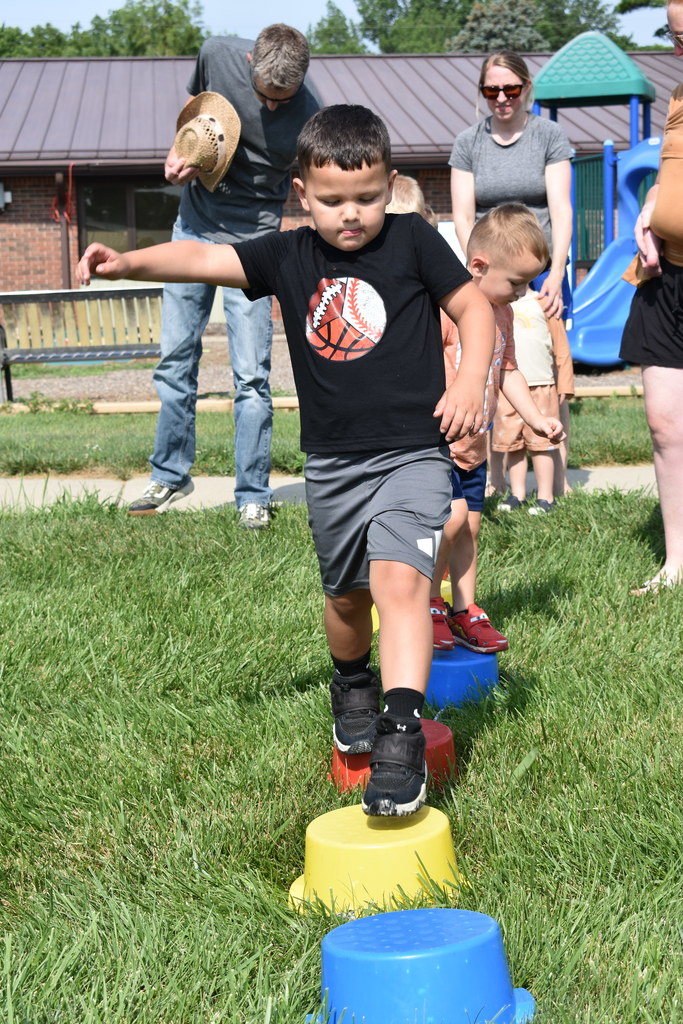 Little boy completing the obstacle course