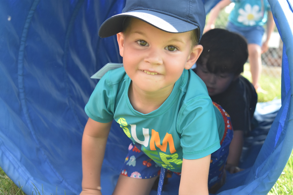 young boy coming out of tunnel