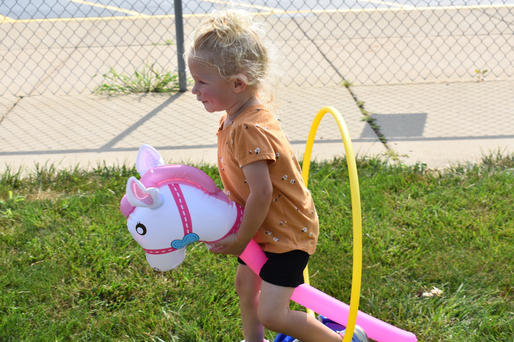 Little girl with horse on obstacle course